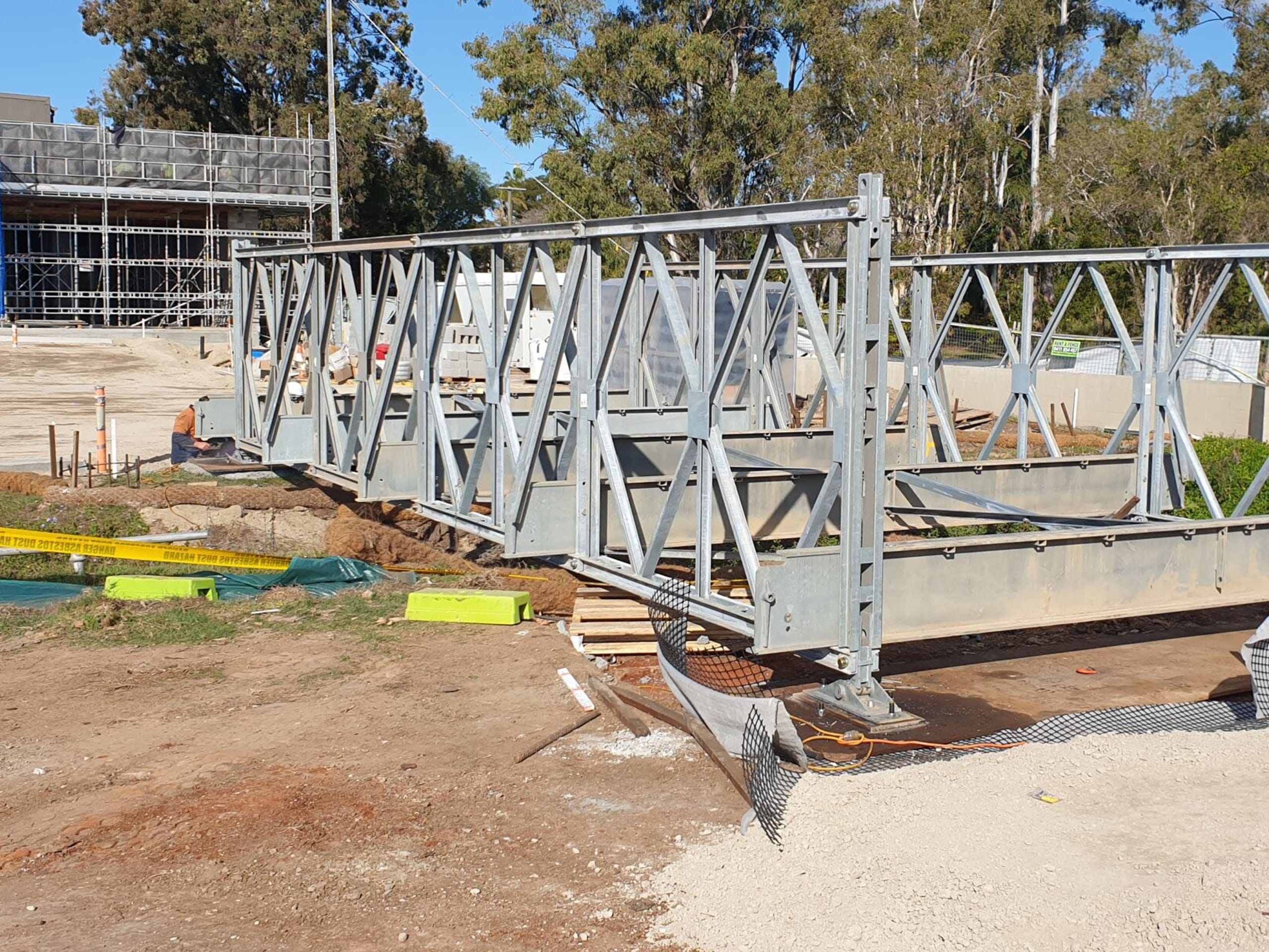 Mabey Compact 200 temporary steel truss bridge spanning a small creek at Wynnum Rugby Leagues Club construction site, Queensland