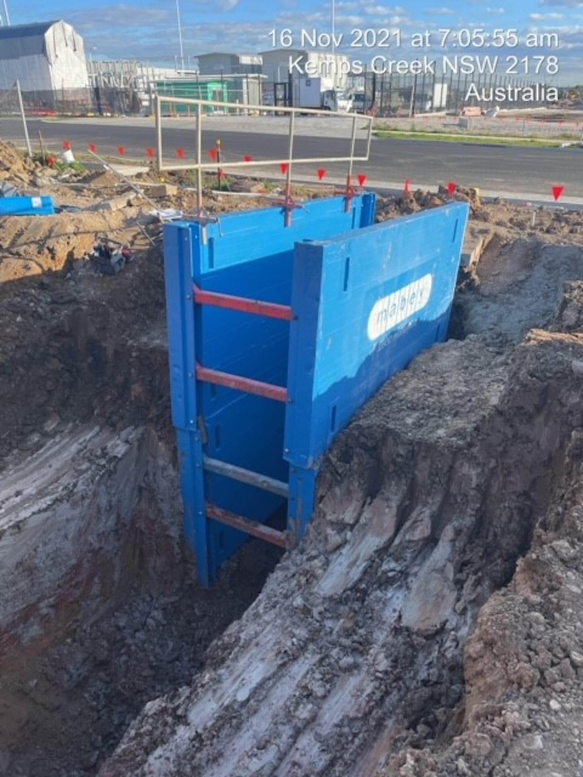 Lightweight trench box with ladder inside excavation at a civil construction site