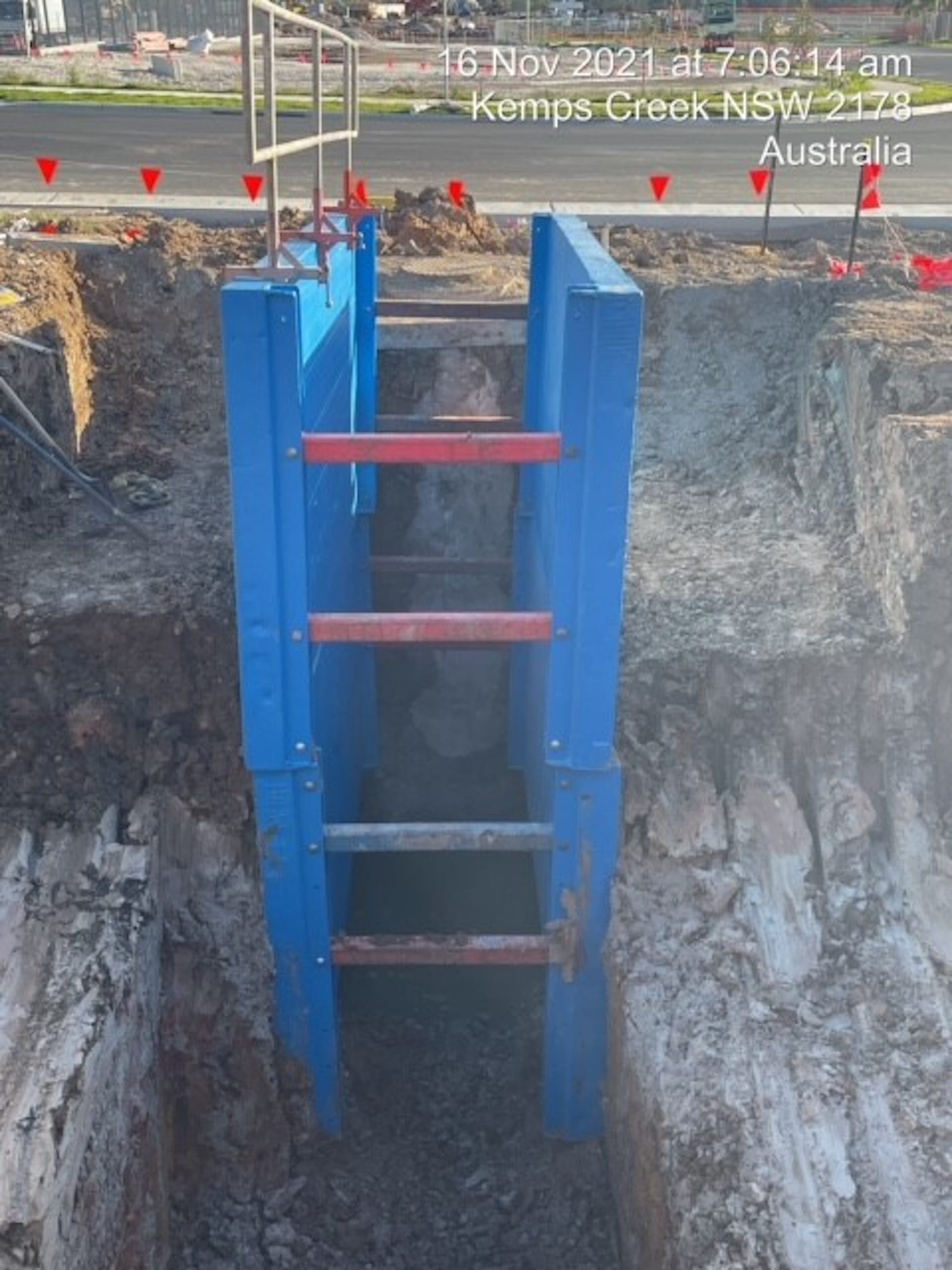 Excavation supported by lightweight trench box and access ladder on site