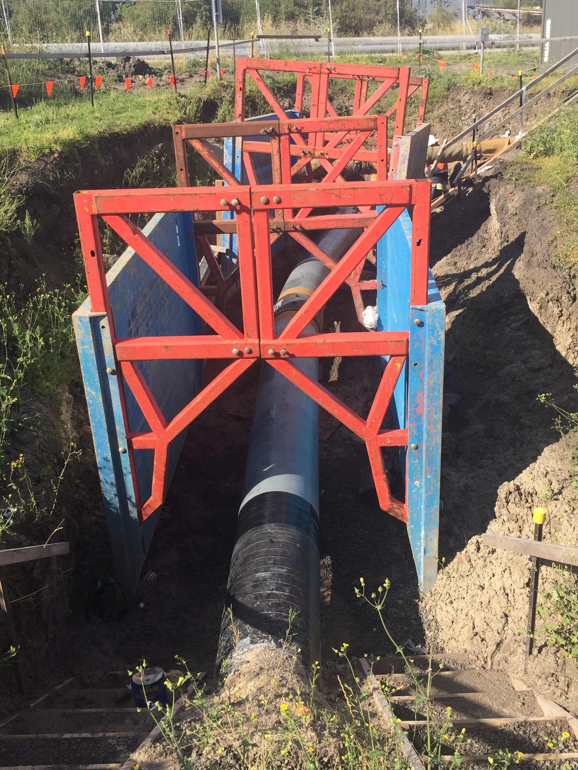 Excavation supported by lightweight trench box and access ladder on site