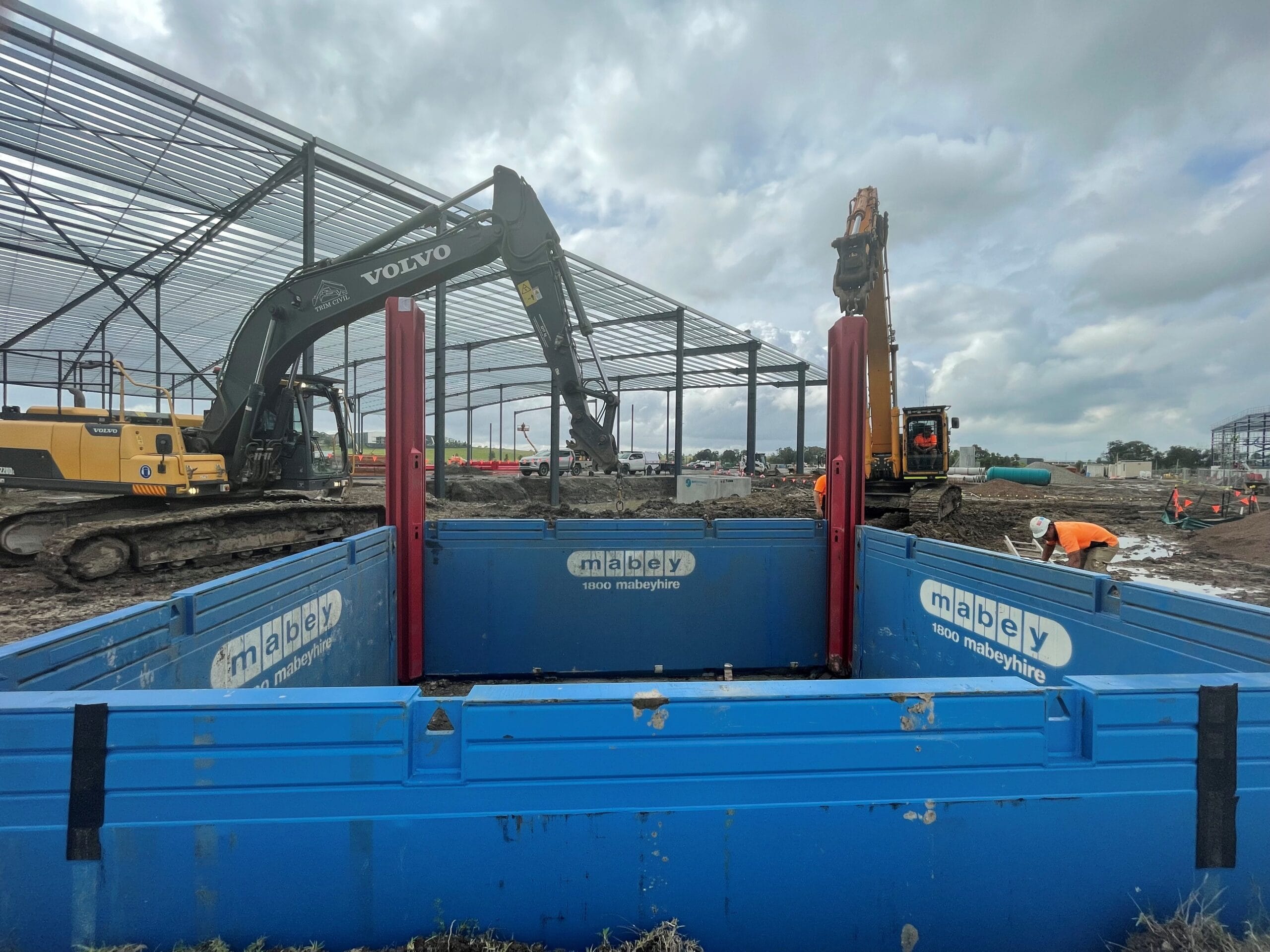Excavators operating with Mabey trench shoring shield in place at site works