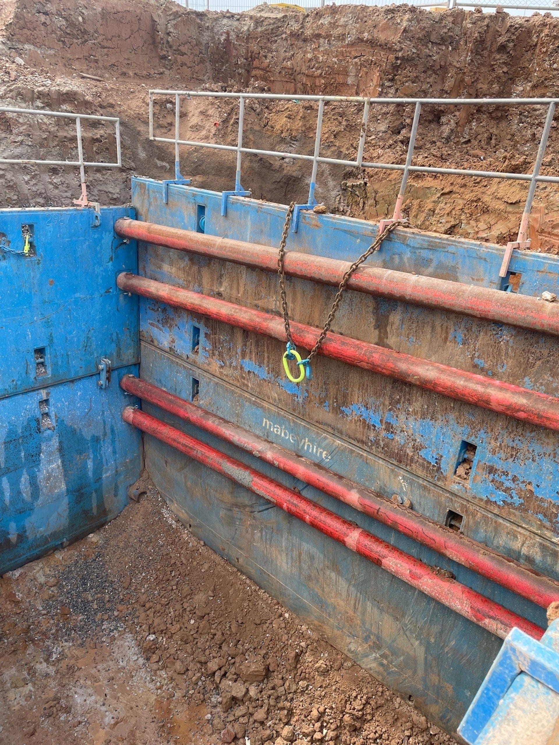 Heavy duty steel trench shields with reinforced rails providing strong and durable shoring in tough ground conditions