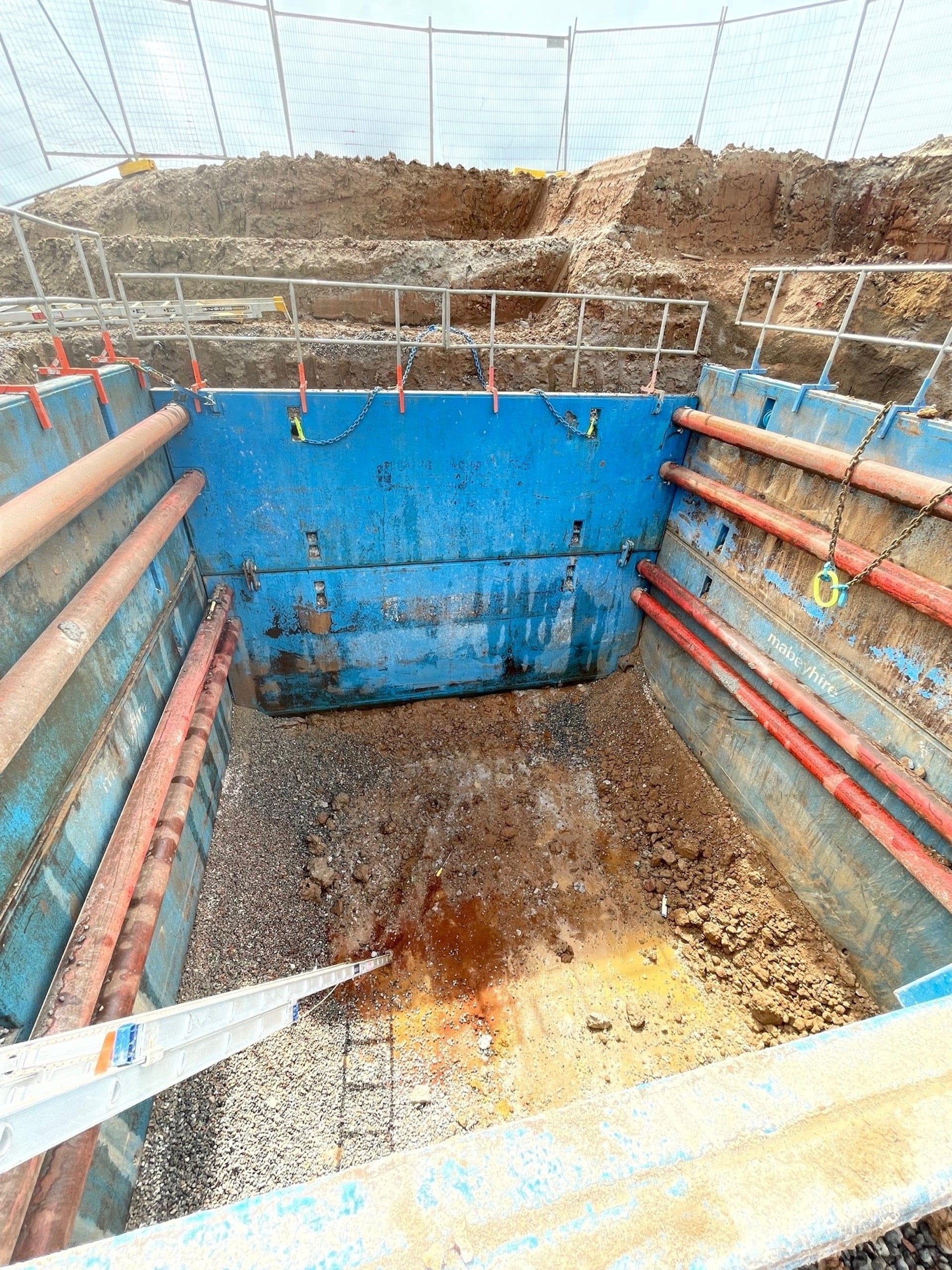 Steel trench box in use on site showing high clearance and durable knife edge for quick installation